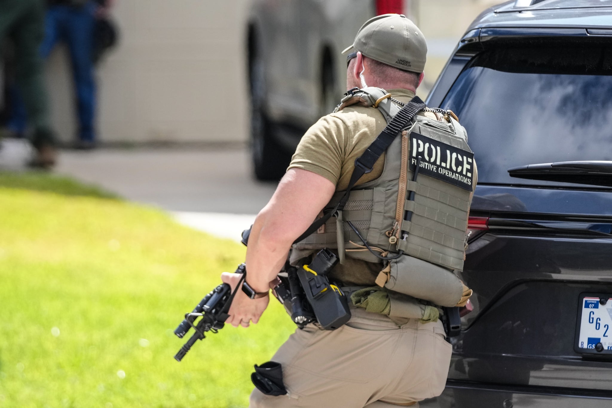 Immigration and Customs Enforcement officers stand outside of a residence on Saint Winfred street after a man who they were pursuing barricaded himself inside the house in Spring, Wednesday, July 8, 2026. Immigration and Customs Enforcement officers stand outside of a residence on Saint Winfred street after a man who they were pursuing barricaded himself inside the house in Spring, Wednesday, July 8, 2026.