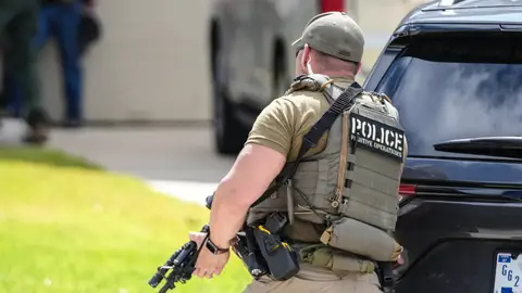 Immigration and Customs Enforcement officers stand outside of a residence on Saint Winfred street after a man who they were pursuing barricaded himself inside the house in Spring, Wednesday, July 8, 2026. Immigration and Customs Enforcement officers stand outside of a residence on Saint Winfred street after a man who they were pursuing barricaded himself inside the house in Spring, Wednesday, July 8, 2026.