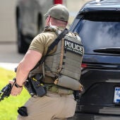 Immigration and Customs Enforcement officers stand outside of a residence on Saint Winfred street after a man who they were pursuing barricaded himself inside the house in Spring, Wednesday, July 8, 2026.