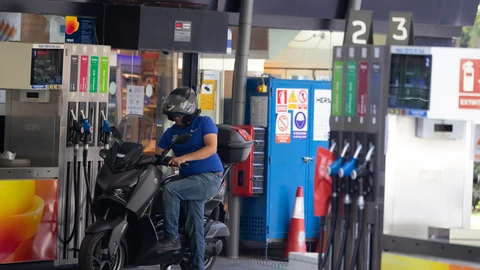 Una motocicleta parando en una gasolinera
