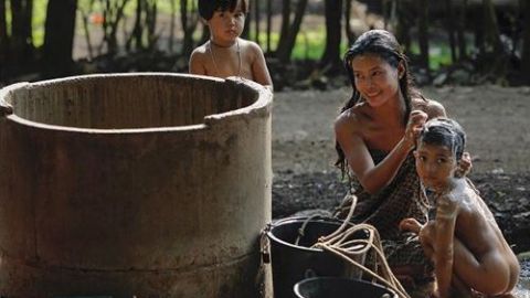Una familia disfruta de un ba&ntilde;o en una comunidad humilde