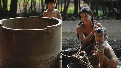 Baño en Familia - Contrapartre Una familia disfruta de un baño en una comunidad humilde