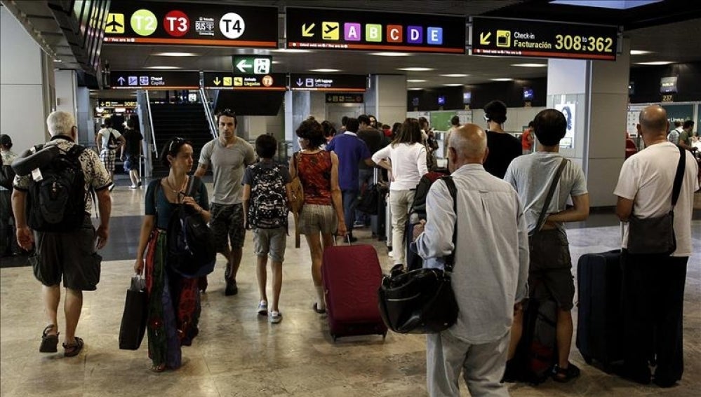 Tráfico denso de viajeros y maletas en el aeropuerto Adolfo Suárez-Barajas, en Madrid