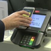 Un hombre paga en un datáfono con su 'smartphone'.