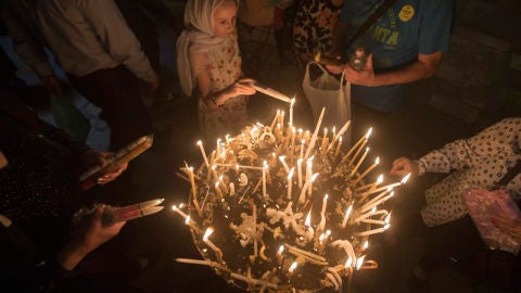 Peregrinos encienden velas en la Iglesia del Santo Sepulcro en el centro antiguo de Jerusal&eacute;n
