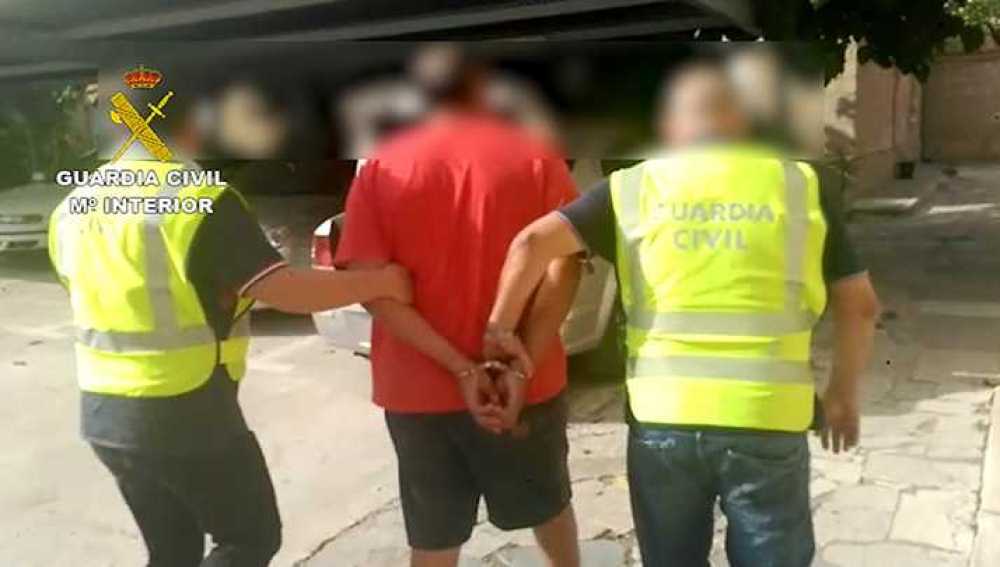 Dos agentes de la Guardia Civil custodian al detenido en Torre-Pacheco