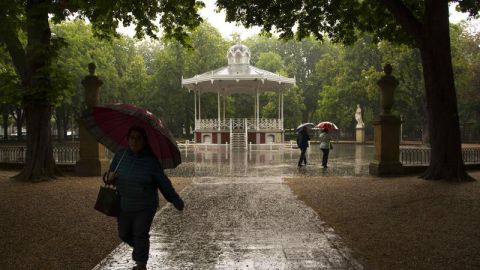 Paseantes se protegen de la lluvia 