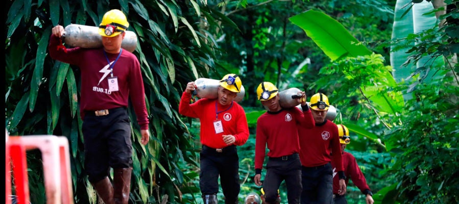 Miembros de los servicios de rescate de Tailandia cargan con botellas de oxígeno Miembros de los servicios de rescate de Tailandia cargan con botellas de oxígeno