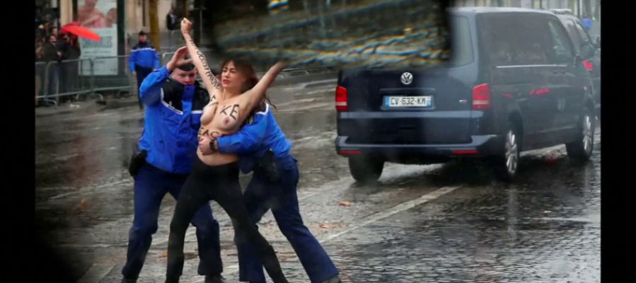 Una activista de Femen, detenida en topless antes de alcanzar la caravana de Trump en el centenario del fin de la Primera Guerra Mundial Una activista de Femen, detenida en topless antes de alcanzar la caravana de Trump en el centenario del fin de la Primera Guerra Mundial