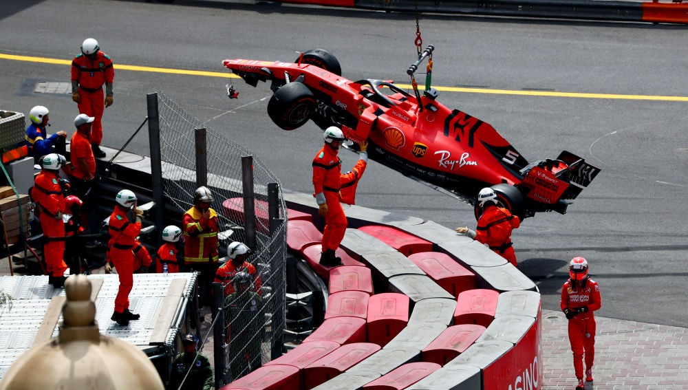 Los operarios retiran el Ferrari de Vettel de la pista tras el accidente del alemán