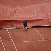 Los operarios de Roland Garros ponen la lona en la Philippe Chatrier