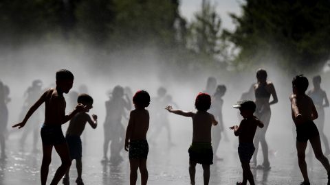 Un grupo de ni&ntilde;os se ba&ntilde;a en las fuentes verticales de Madrid R&iacute;o.