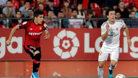 El jugador del Real Madrid, Odriozola, disputa el bal&oacute;n con el del Mallorca, Fran G&aacute;mez
