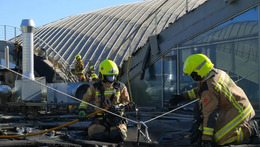 Bomberos en las tareas de extinción del incendio en el aeropuerto Alicante-Elche. 