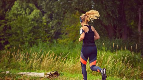 Mujer practicando running mientras escucha m&uacute;sica