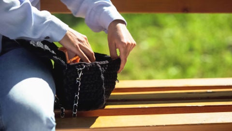 Una mujer revisa su bolso