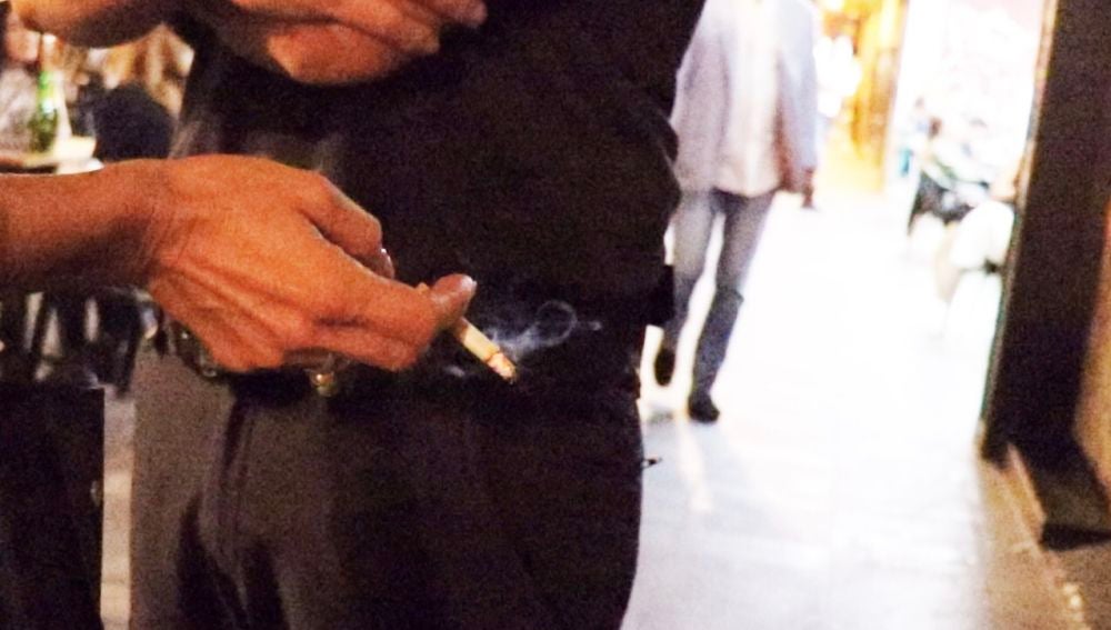 Un agente con una persona fumando, anoche.