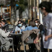 Cuatro personas en la terraza de un bar en Sevilla