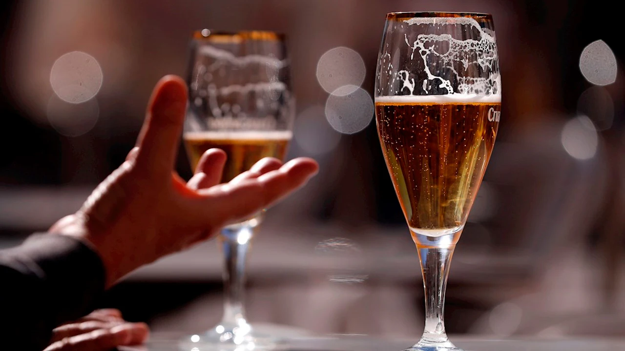 Un hombre tomando unas cervezas en una terraza