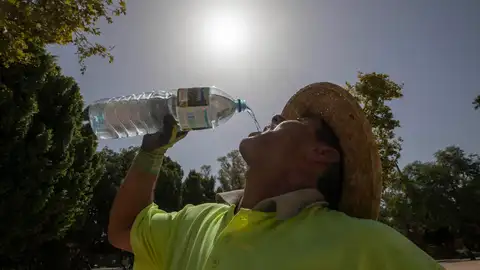 Un trabajador de la construcción bebe agua durante un descanso.