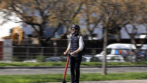 Hombre en patinete eléctrico con casco