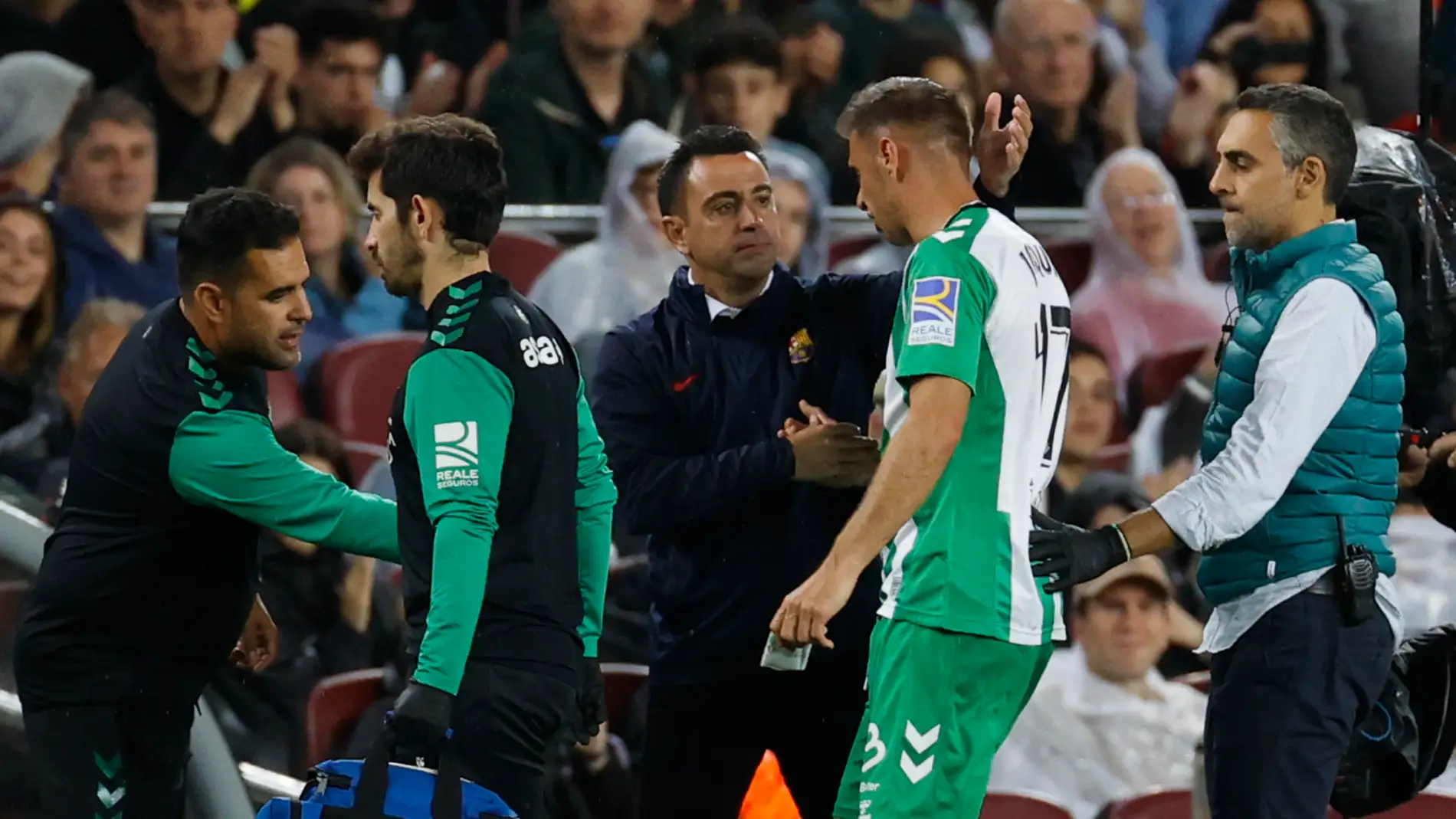 Joaquín saluda a Xavi Hernández, entrenador del FC Barcelona, antes de retirarse para ser atendido por el equipo médico.