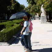 Varios turistas se protegen del sol en Madrid.