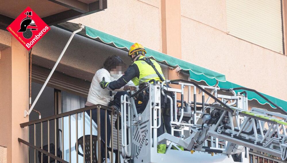 Los bomberos ayudan a bajar a una mujer por la autoescalera