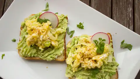 Dos rebanadas de pan de molde con guacamole Dos rebanadas de pan de molde con guacamole