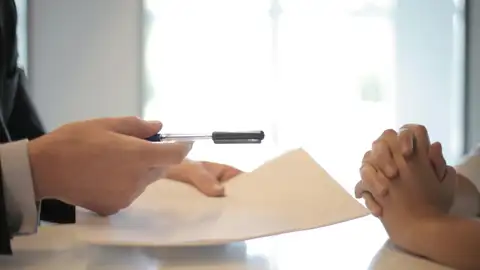 Dos personas que van a firmar un documento | Foto de archivo Dos personas que van a firmar un documento | Foto de archivo