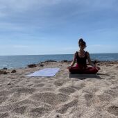 Adriana Sanz, haciendo yoga en la playa. 