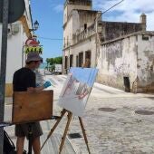 Artista pintando en una calle.
