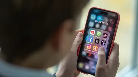Un móvil que muestra los diferentes iconos de las redes sociales. Un móvil que muestra los diferentes iconos de las redes sociales.