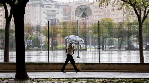 Una persona pasea este lunes bajo la lluvia en Castellón. Una persona pasea este lunes bajo la lluvia en Castellón.
