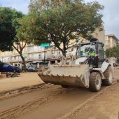 Excavadora retirando el barro de las calles 