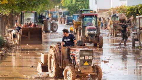 Agricultores con tractores en las zonas devastadas. 