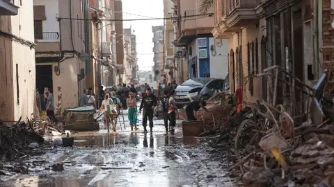 Varias personas caminan entre el lodo acumulado en las calles de Catarroja a causa de las intensas lluvias caídas por la DANA. Varias personas caminan entre el lodo acumulado en las calles de Catarroja a causa de las intensas lluvias caídas por la DANA.
