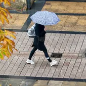 Una persona se refugia de la lluvia en Logroño Una persona se refugia de la lluvia en Logroño