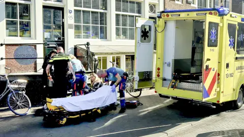 Los trabajadores de ambulancia ayudan a una víctima de apuñalamiento Los trabajadores de ambulancia ayudan a una víctima de apuñalamiento