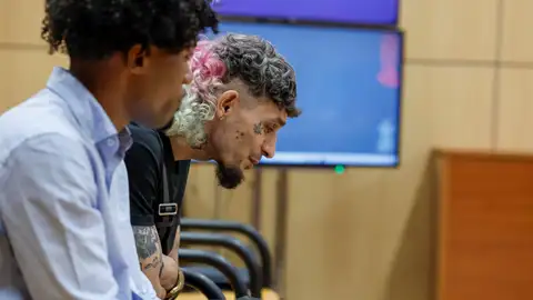 Los raperos David Calvo Villa, más conocido por su nombre artístico 'El Jincho' (d) y `Osiris´durante el juicio por un delito de violación para los que la Fiscalía pide 13 años de prisión por agredir sexualmente a una joven en el hotel en el que se alojaban tras dar un concierto de rap en Mislata (Valencia) el 4 de noviembre de 2023. Los raperos David Calvo Villa, más conocido por su nombre artístico 'El Jincho' (d) y `Osiris´durante el juicio por un delito de violación para los que la Fiscalía pide 13 años de prisión por agredir sexualmente a una joven en el hotel en el que se alojaban tras dar un concierto de rap en Mislata (Valencia) el 4 de noviembre de 2023.