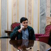 El periodista Vito Quiles habla por teléfono durante una sesión plenaria en el Congreso