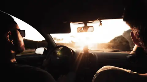 Imagen de archivo de una persona conduciendo durante un atardecer Imagen de archivo de una persona conduciendo durante un atardecer