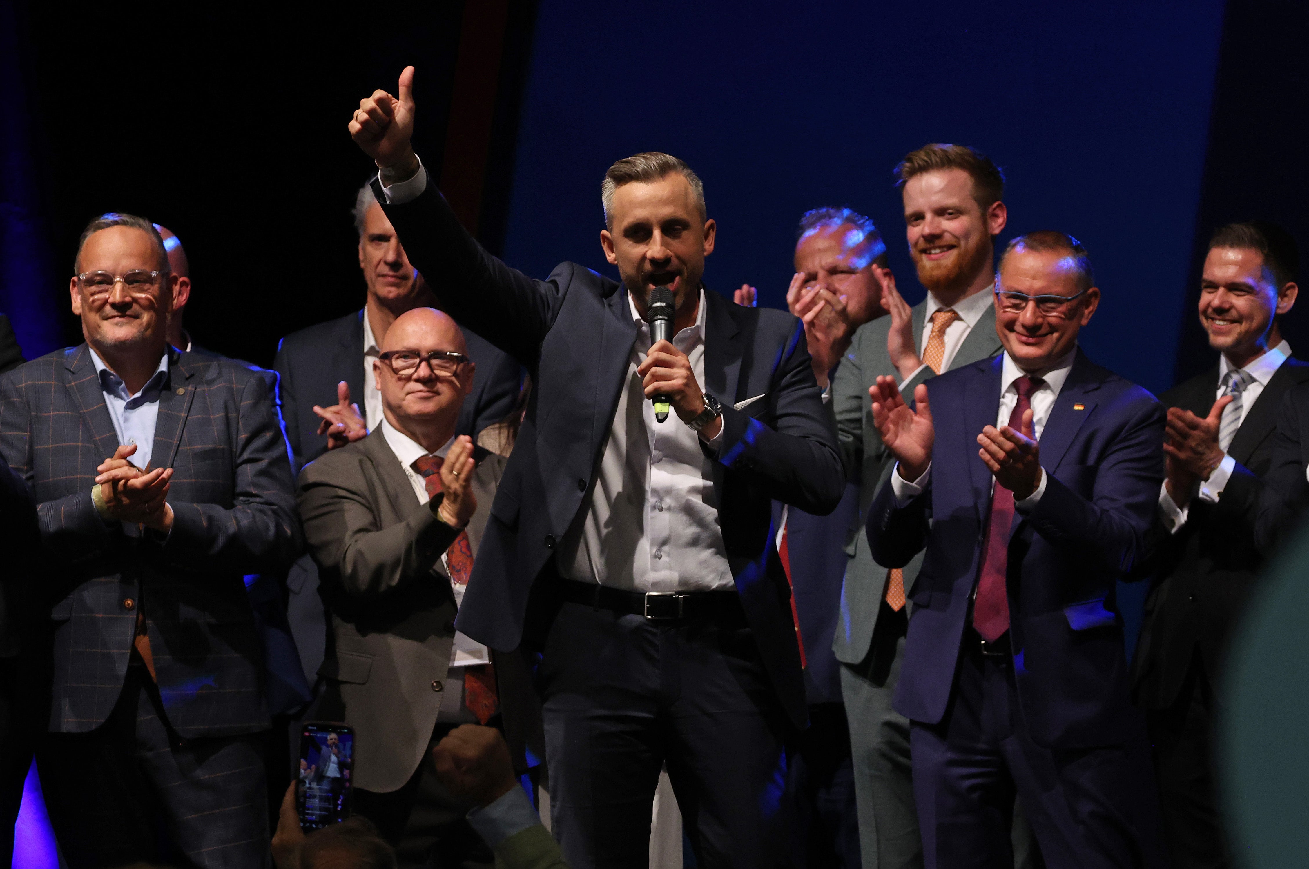 Ulrich Siegmund (C), lead candidate of the far-right Alternative for Germany (AfD), gestures on stage as AfD co-leader Tino Chrupalla (2nd from R) and AfD Saxony-Anhalt Chairman Martin Reichardt (L) look on at the AfD election evening watch party after initial results give the party 44.8% of the vote in Saxony-Anhalt state elections on September 6, 2026 in Magdeburg, Germany. Ulrich Siegmund (C), lead candidate of the far-right Alternative for Germany (AfD), gestures on stage as AfD co-leader Tino Chrupalla (2nd from R) and AfD Saxony-Anhalt Chairman Martin Reichardt (L) look on at the AfD election evening watch party after initial results give the party 44.8% of the vote in Saxony-Anhalt state elections on September 6, 2026 in Magdeburg, Germany.