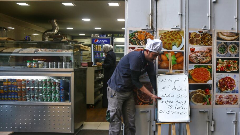 24 de diciembre de 2019, L&iacute;bano, Beirut: Un comerciante coloca un cartel en &aacute;rabe que dice: &laquo;Si no tienes dinero, no te averg&uuml;ences ni dejes a tu familia sin comida. Por favor, entra y coge lo que necesites&raquo;, a la entrada de una peque&ntilde;a panader&iacute;a en una zona residencial de Beirut.